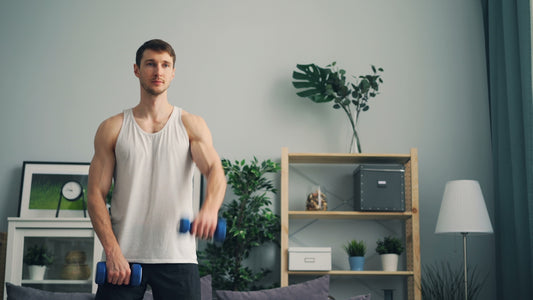 a man holding two dumbs in a living room