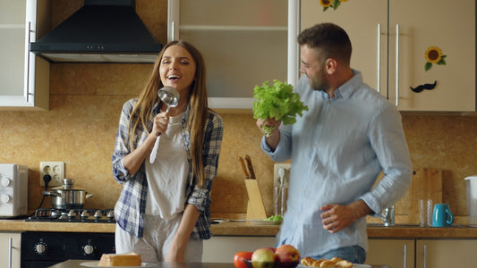 Couple singing and dancing in a bright kitchen